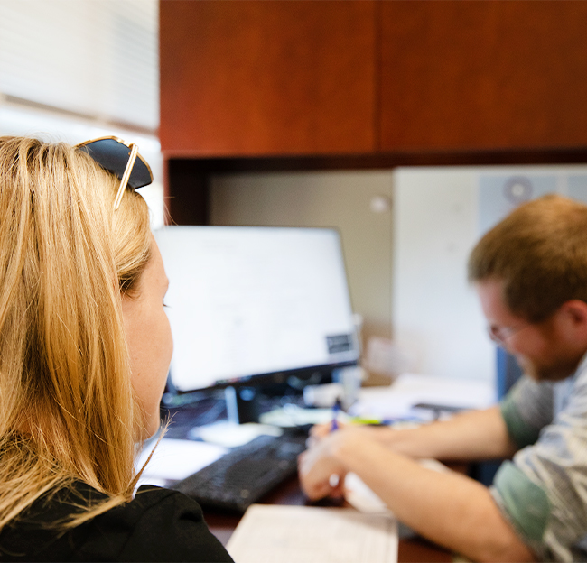 A student meeting with an advisor for course scheduling.