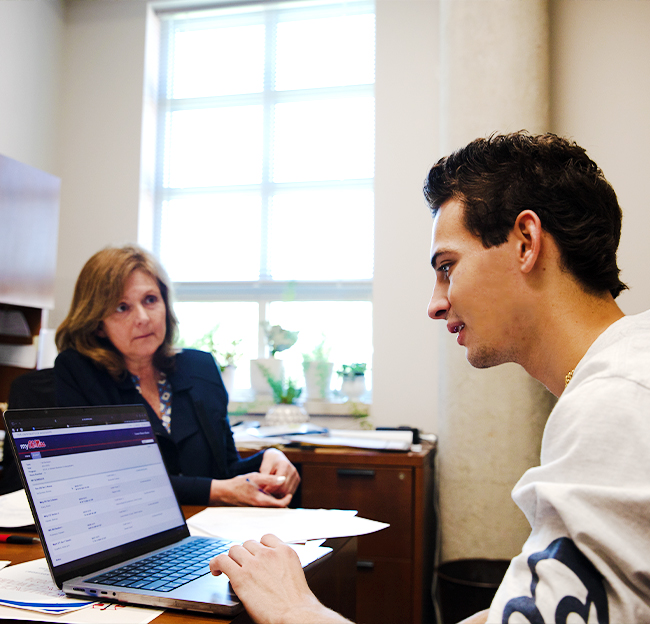 A student meeting with an advisor for course registration.