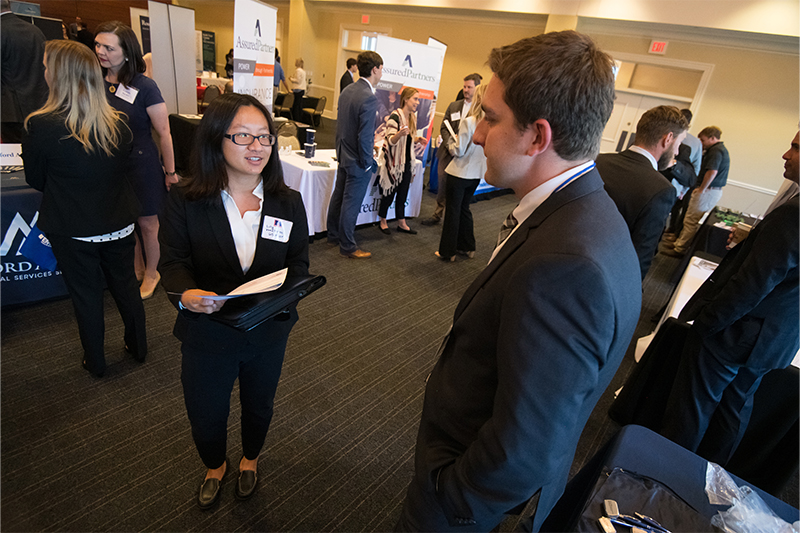 Student introducing herself to an employer during a career fair.