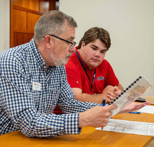 Jay Barfield (left) advising an incoming student (right).