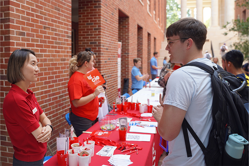 Tong Meng speaking with a student during Open for Business.