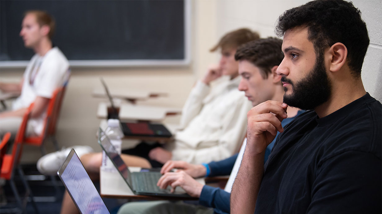 Students in a classroom setting pondering on a question.
