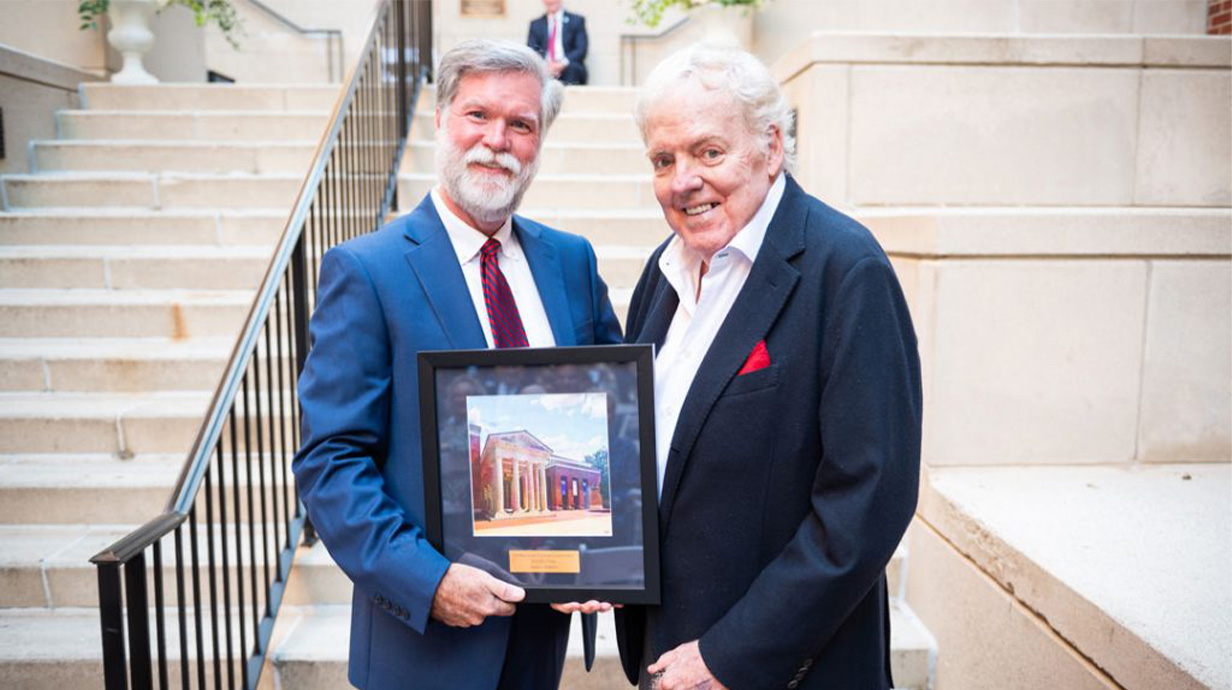 In October 2024, Jim Barksdale was included among the first inductees into the UM School of Business Administration Hall of Fame. Here, Business Dean Ken Cyree (left) presents Barksdale his award.