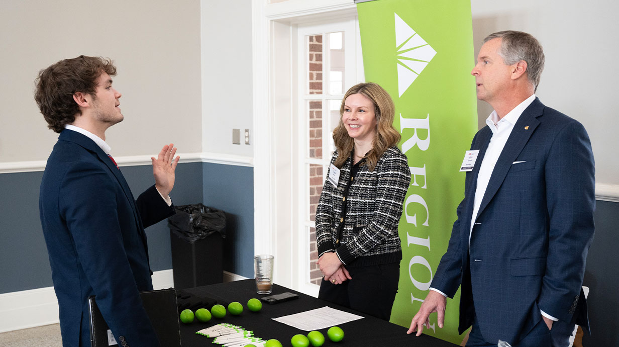 John Morgan, a sophomore in general business, visits with a representative from Regions Bank at the first annual Futures in Finance Event on Feb. 13 at Johnson Commons. Photo Credit: Frank Estrada
