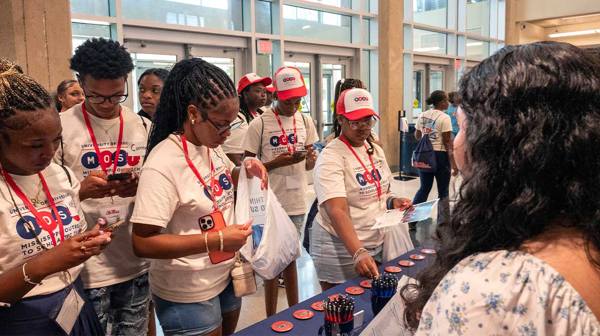 Suzzette Salazar (right) are behind a table explaining what the School of Business has to offer to student during the MOST Conference in the Student Union.