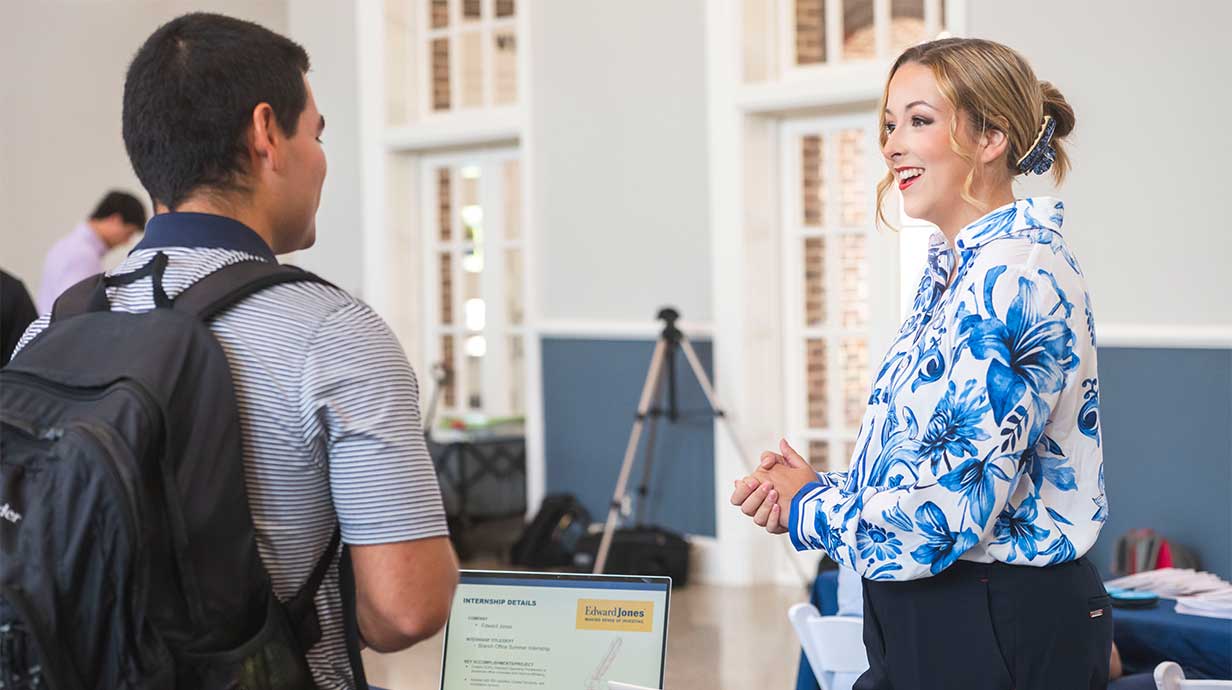 John Wicks, a senior majoring in journalism Jackson, Mississippi, visits with Mya Seek, a sophomore from St. Louis, Missouri, at the UM Internship Showcase. Seek is pursuing a dual degree in finance and public policy leadership. Photo Credit: Srijita Chattopadhyay