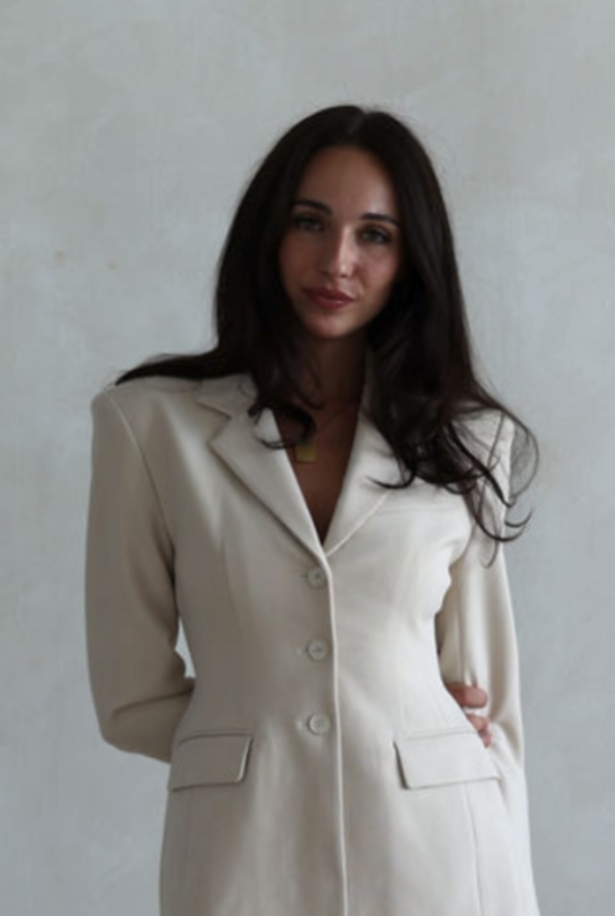 Photo of Natalie Filippi in a white suit.