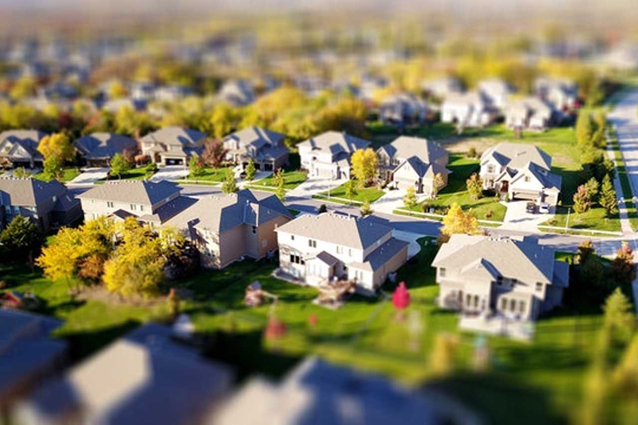 A neighborhood of homes with the first street in focus and the rest are blurred out. Credit: David McBee