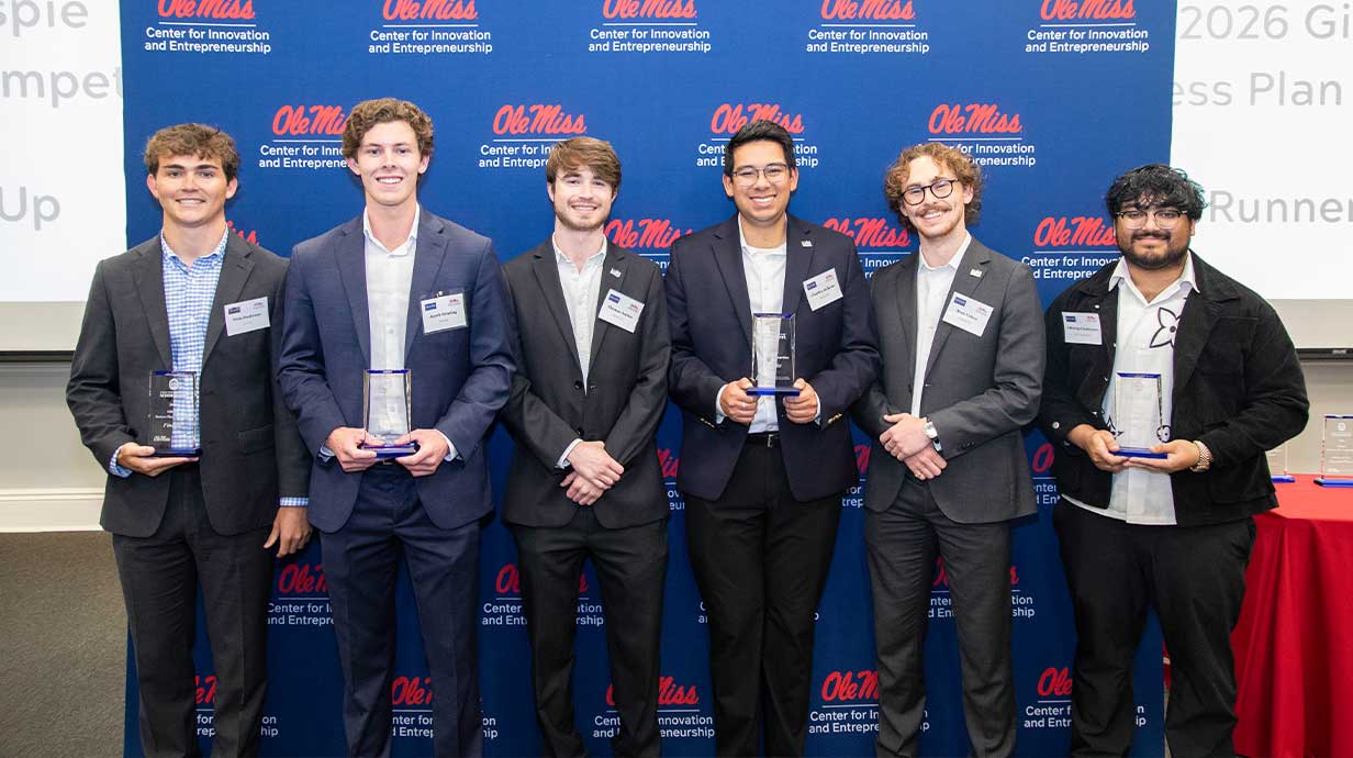 Five award winners posing for a photo with their awards during the Gillespie Business Competition.