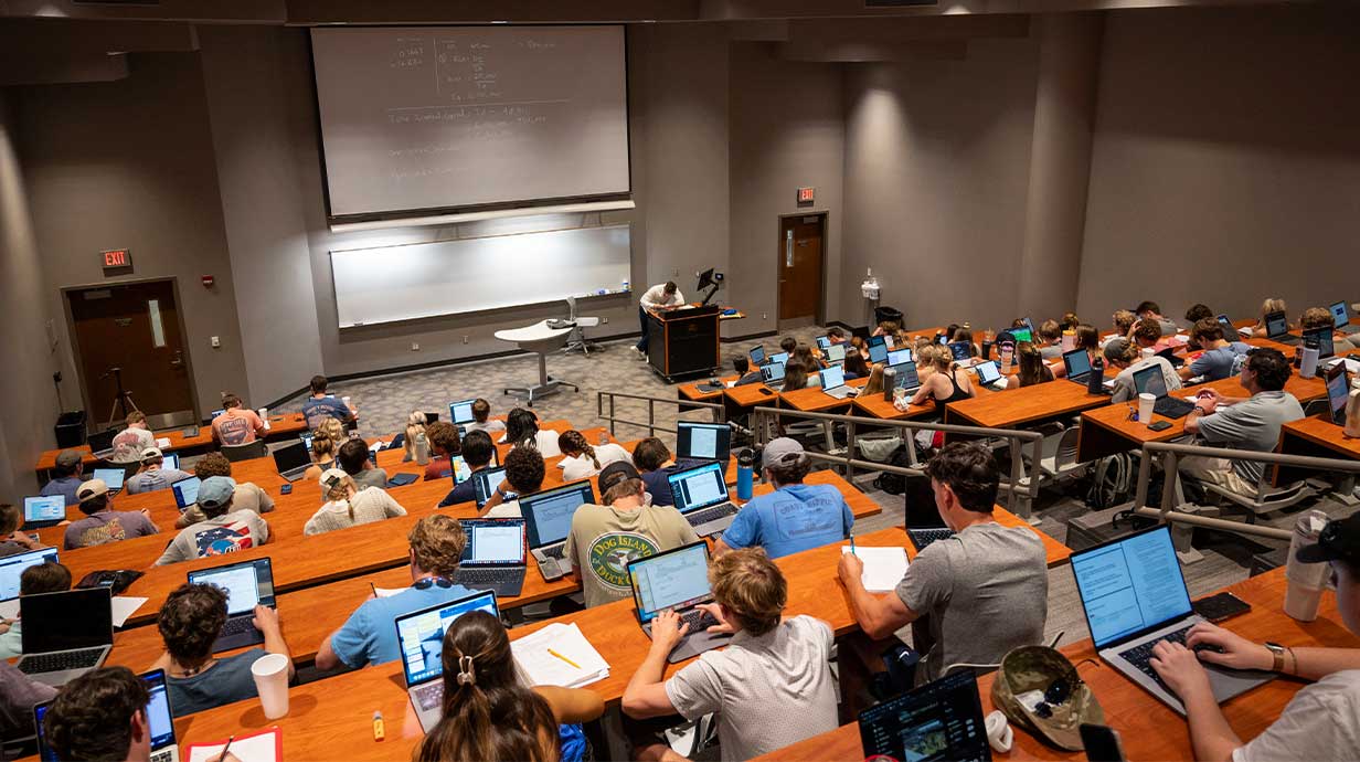 Michael Coccia teaches in Lamar Hall with a class room of students.