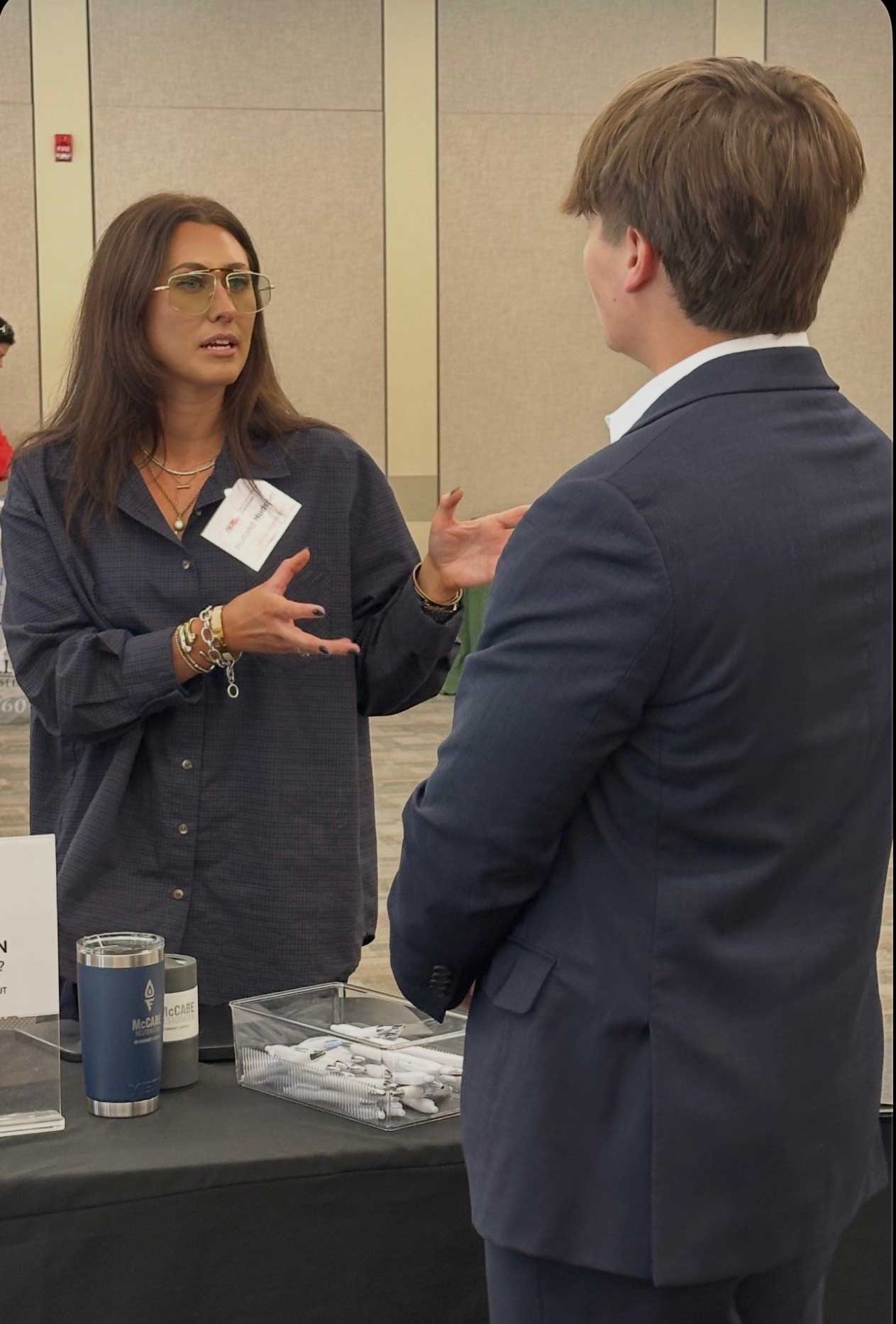 Holland Hudspeth of McCabe Restoration of Memphis discusses career opportunities with a student attending the Real Estate Career Fair. 