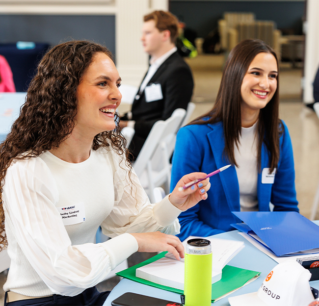 Two female students during the BASE Summit event in the spring of 2024.