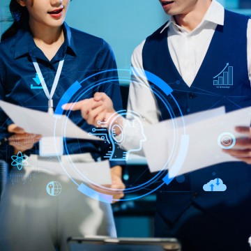 Canva Image: A female and male business team analyzing data with AI technology, futuristic collaboration showcasing innovation, digital transformation, and modern teamwork in a smart office.