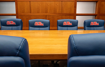 Office chairs in a conference room with Ole Miss embroidered on the seat.