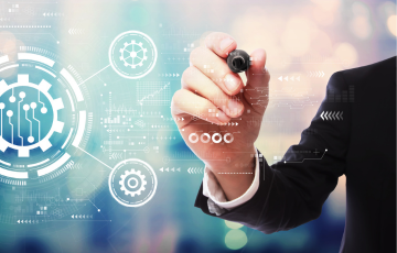 A business person writing on a transparent board with ai automation or augmented reality images of gears, arrows, and graphs on screen.