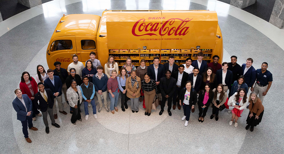 Group photo of students and staff from the Ole Miss Business School with Coca-Cola employees.