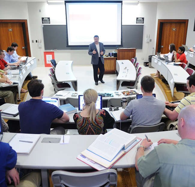 A teacher speaking to a group in a classroom located in Conner Hall.