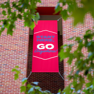 Start Here, Go Anywhere banner outside Holman Hall.