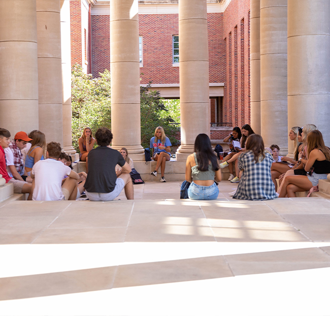 Students under the pavilion during orientation.