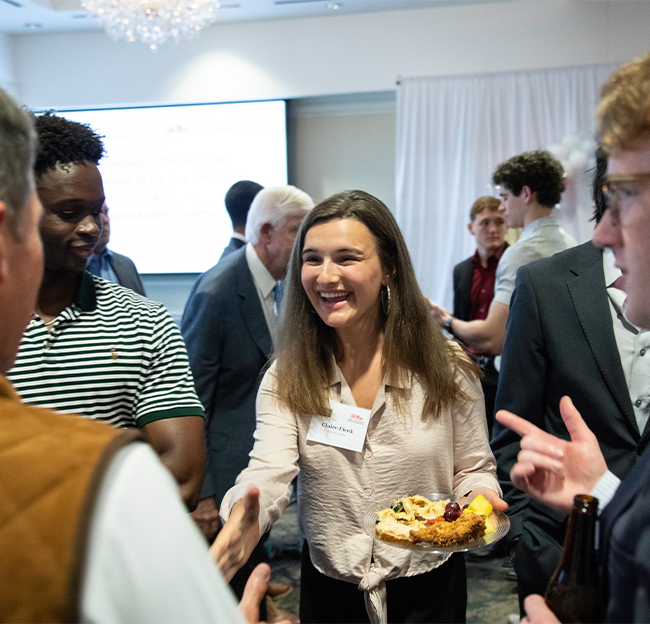 Claire Ficek networking during a reception.