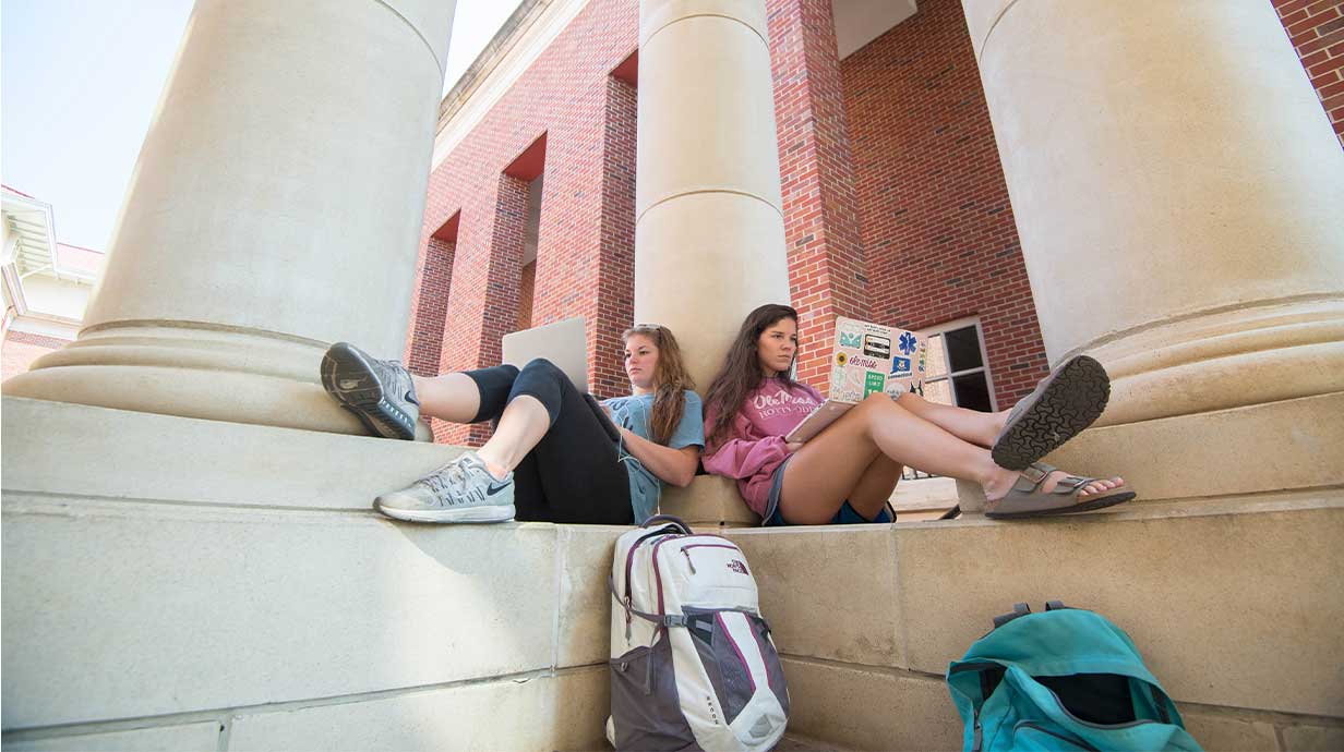 Baleigh Osborne, left, and Julia Scavetta take advantage of the cooler temps and study outside in the business school pavilion.Photo by Kevin Bain/Ole Miss Communications